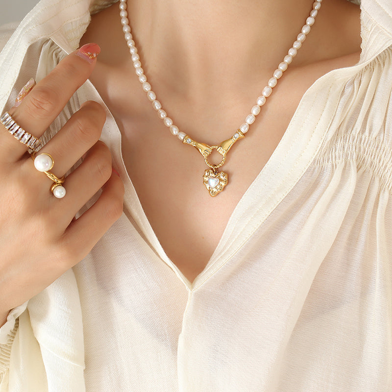 two hands coming together pearl necklace