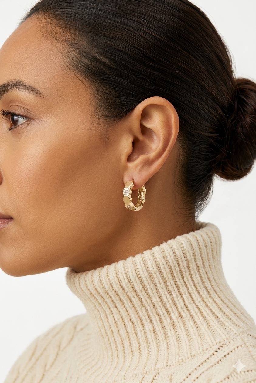 woman wearing hexagonal honeycomb huggie earrings