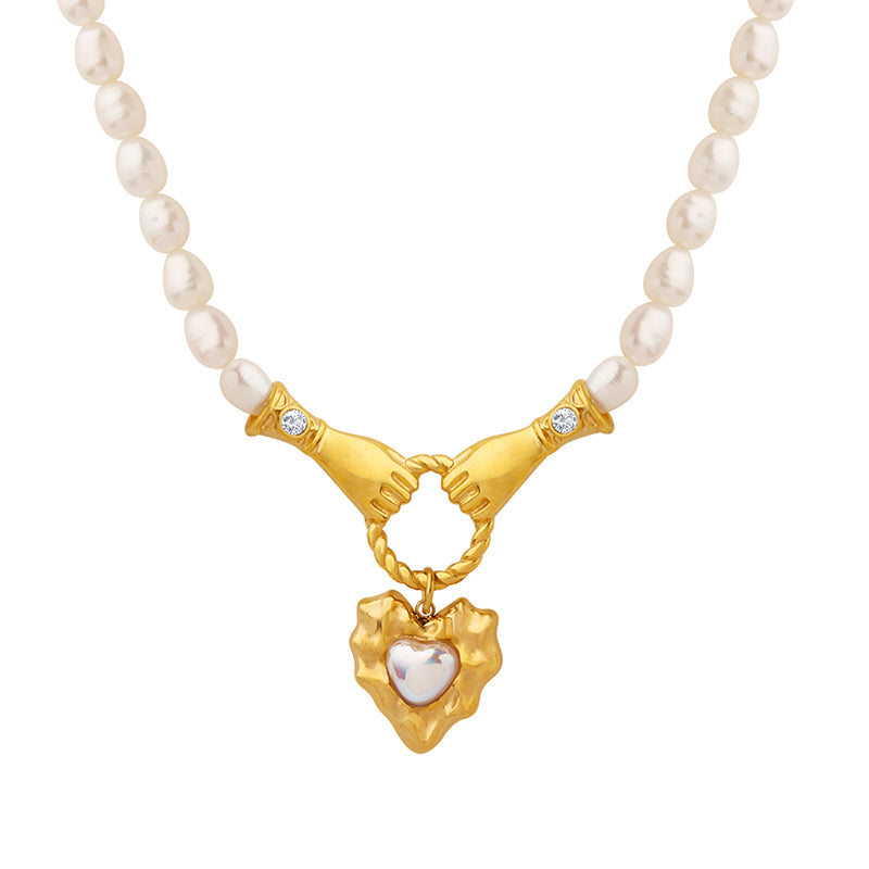 two hands holding a ring pearl necklace