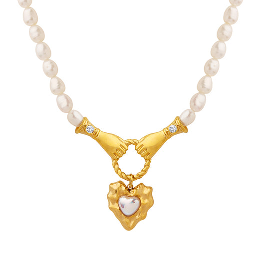 two hands holding a ring pearl necklace